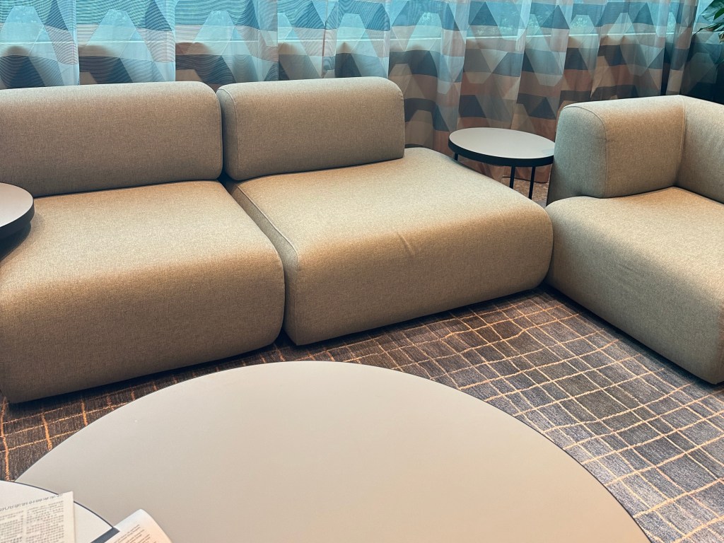 Comfortable lounge seating area with modern couches at Citadines Rochor Singapore