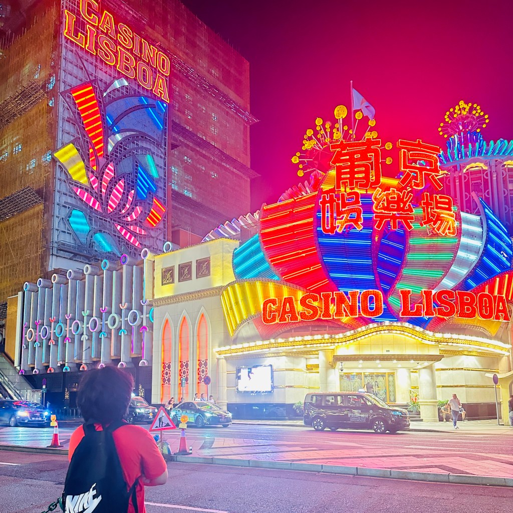 Casino Lisboa in Macau China with bright neon signs and colorful lights at night