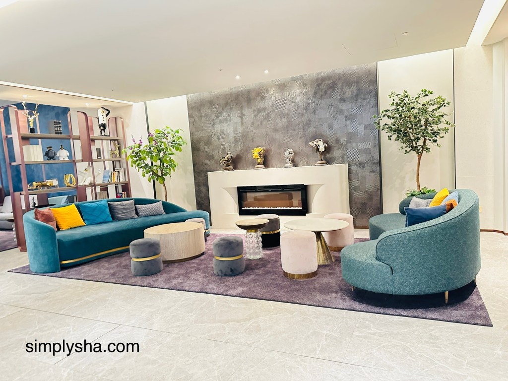 Lounge area with 2 green sofas