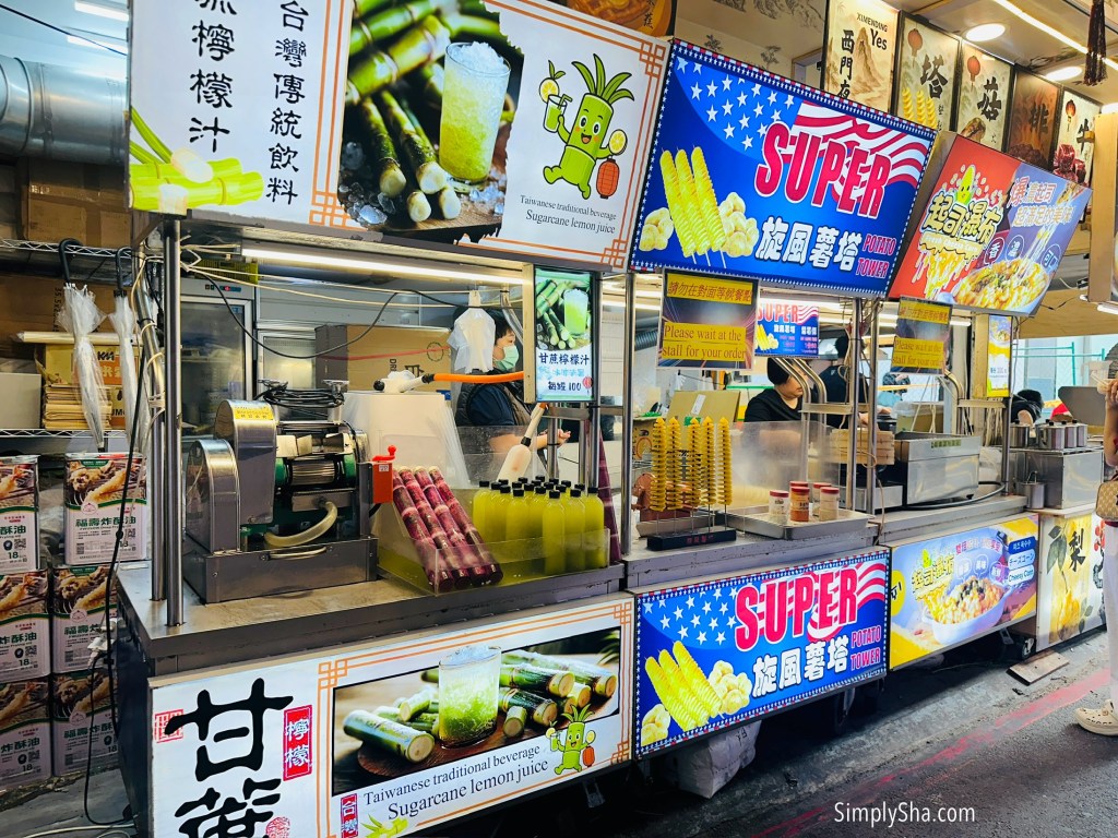 Ximending night market food stalls selling grilled snacks and fresh juices