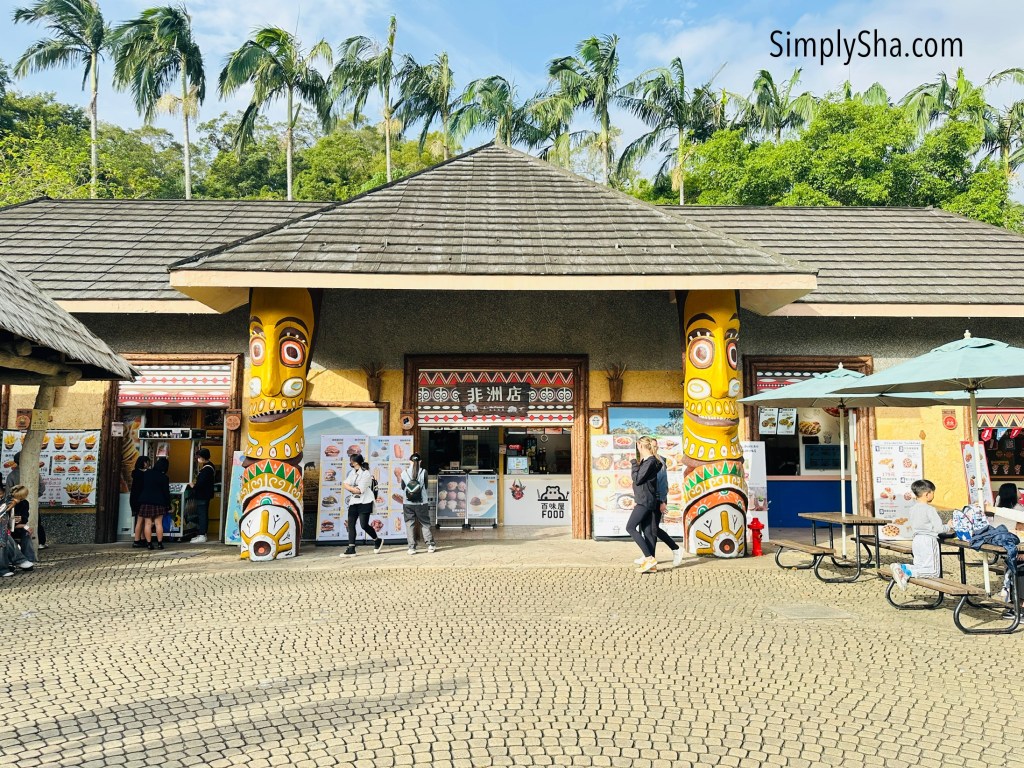 Food court area inside Taipei Zoo with colorful columns and visitors resting and dining