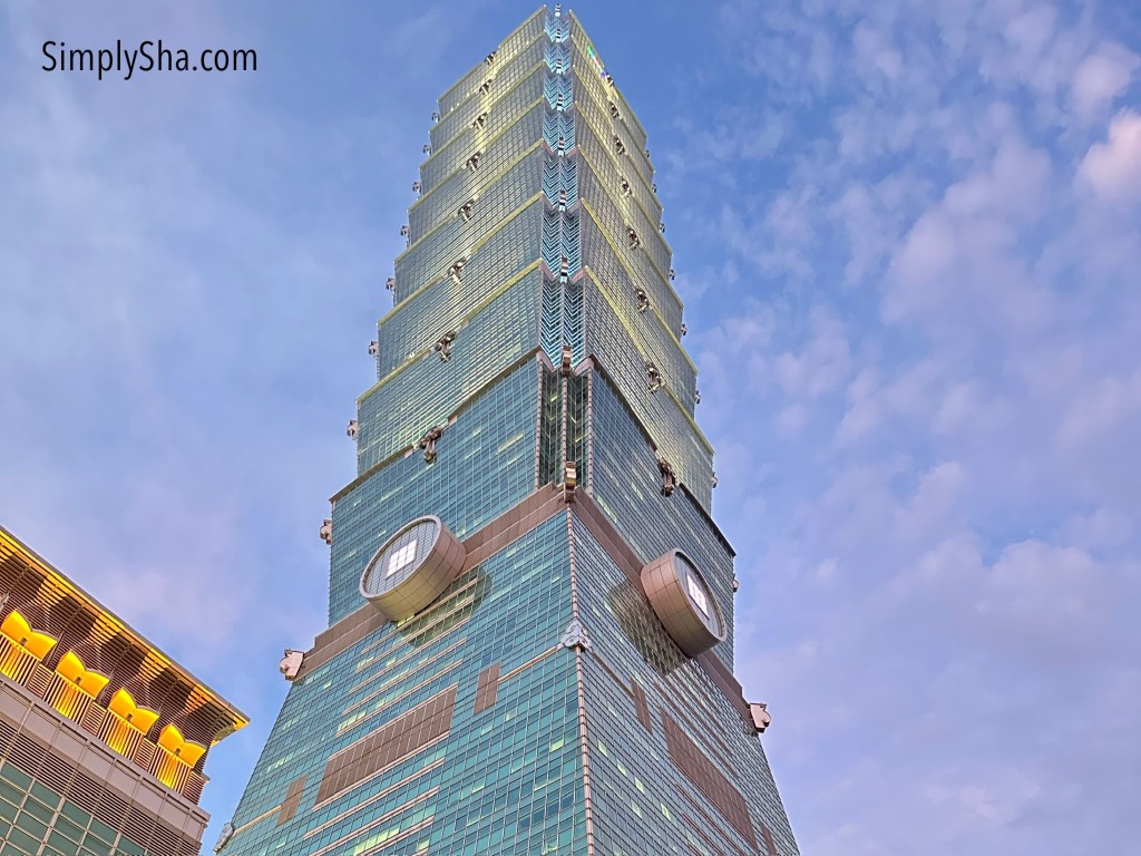 Taipei 101 skyscraper viewed from below against a blue sky in Taipei City