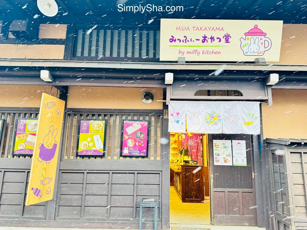 Colorful traditional shop facade in Sanmachi Suji Old Street, Takayama during snowfall