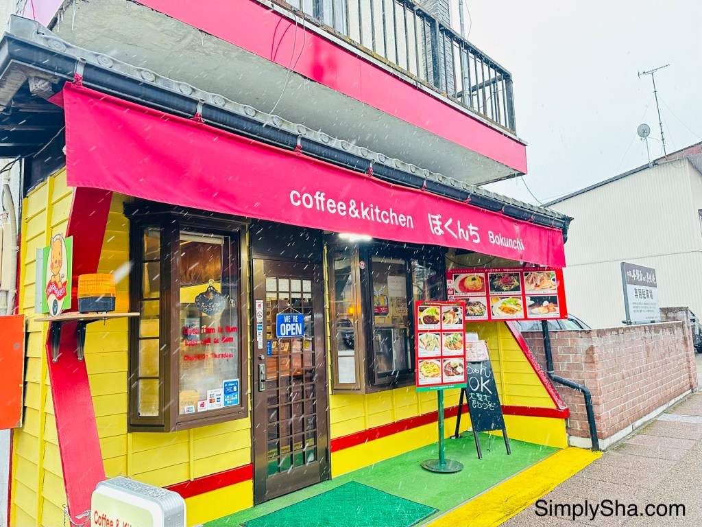 Colorful local cafe exterior on a snowy street in Takayama