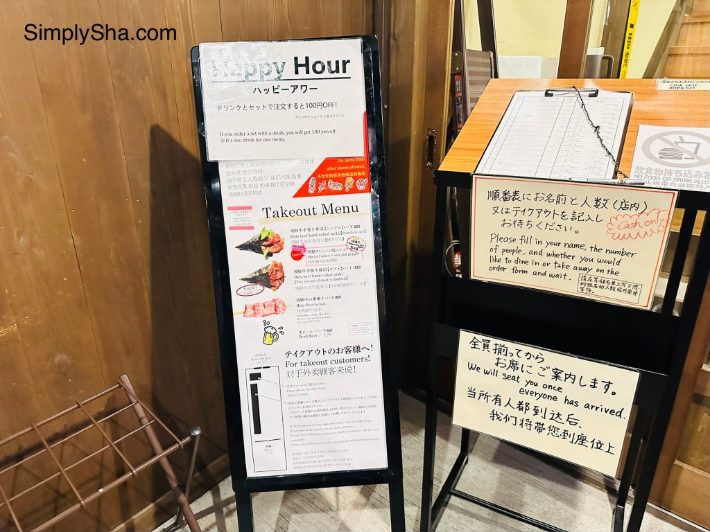 Restaurant menu board featuring Hida beef dishes in Takayama