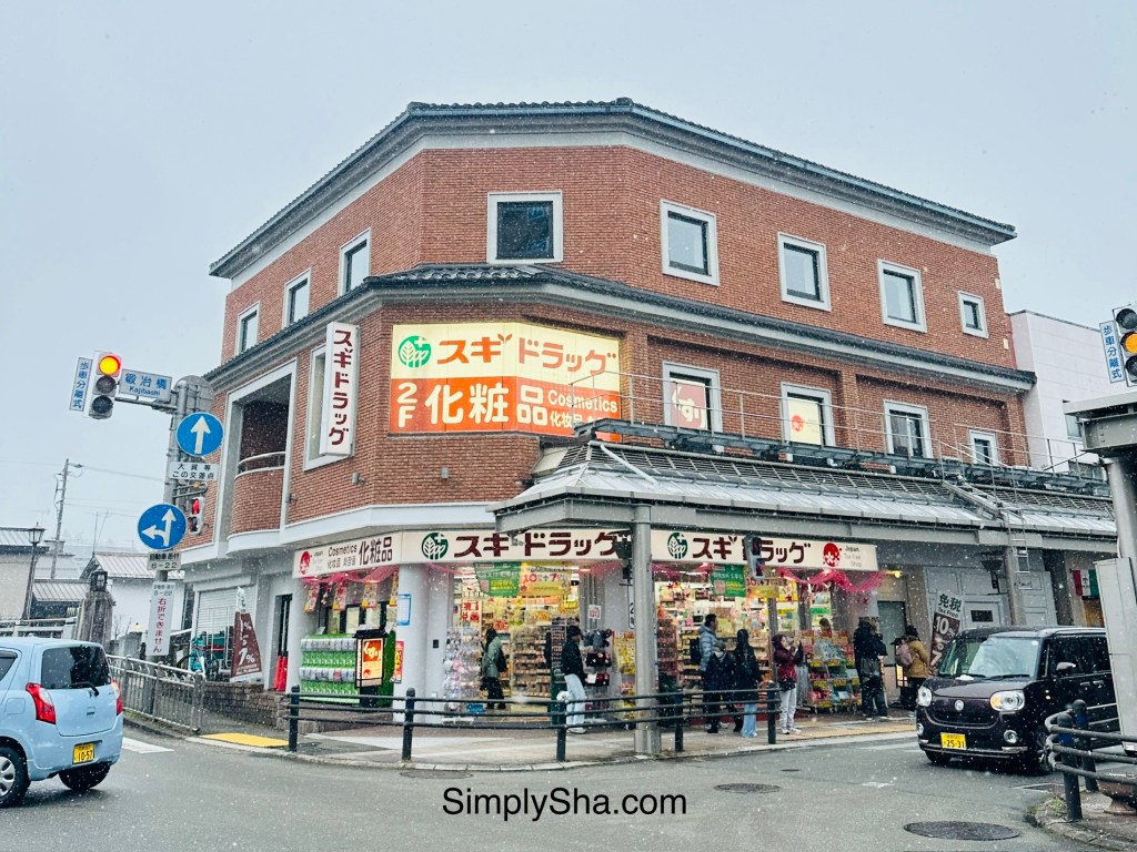 Drugstore and street intersection in Takayama, Japan with snowy winter atmosphere