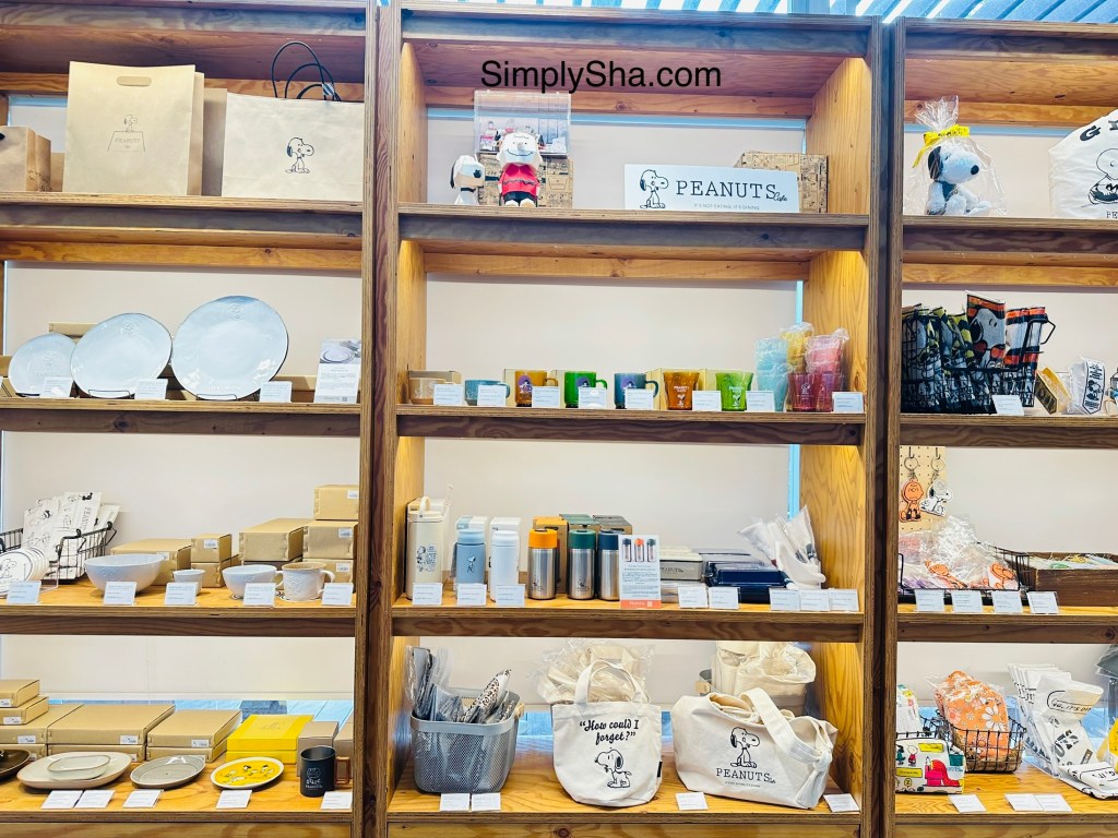 Peanuts Cafe merchandise display with mugs and souvenirs in Nagoya