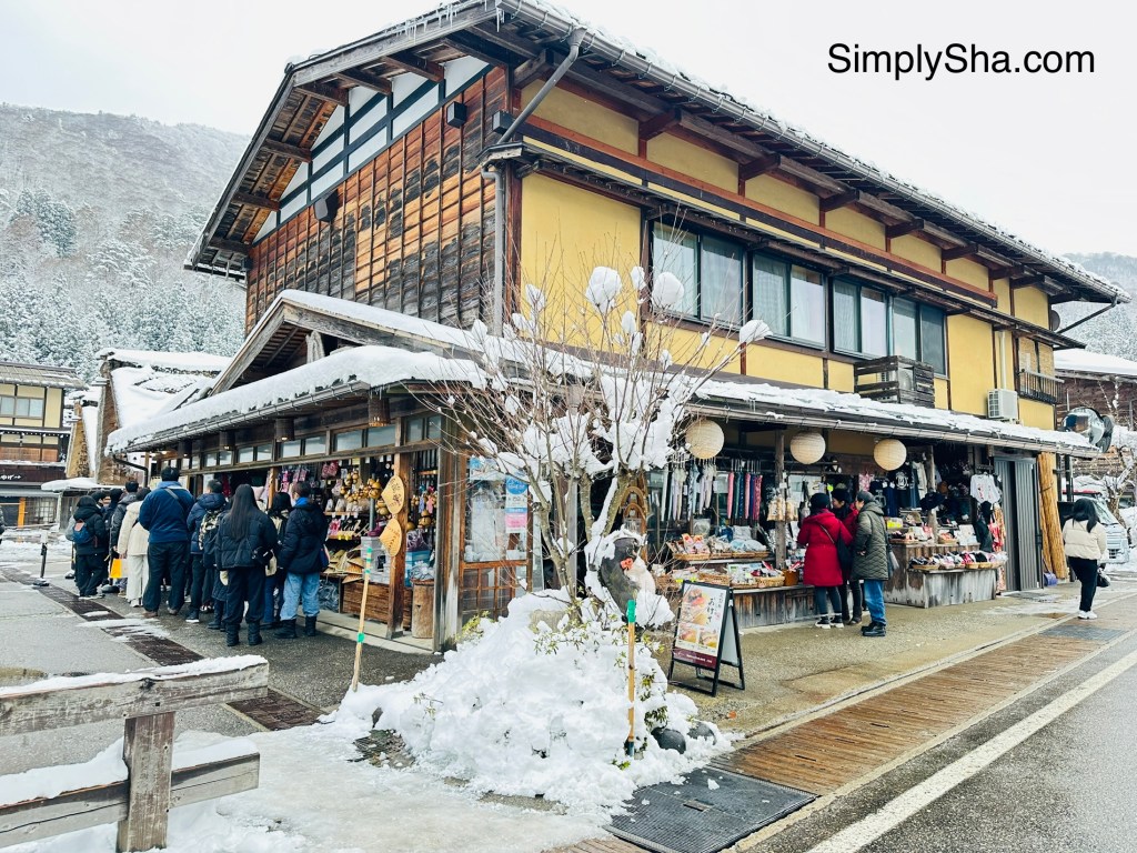 traditional building and street view in Shirakawa-go with visitors during winter