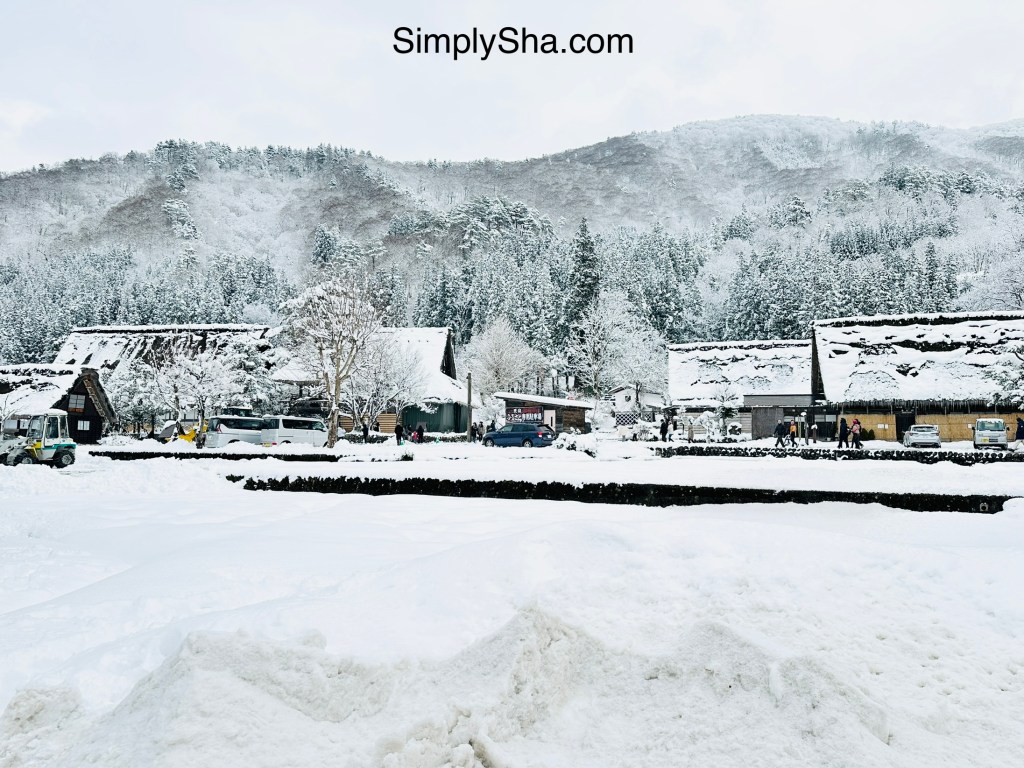 winter scene in Shirakawa-go with snow-covered houses and mountain backdrop