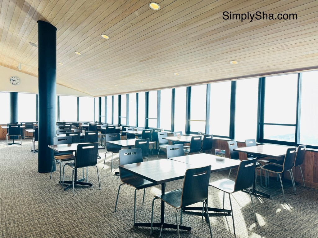 restaurant seating area at Mt. Gozaisho summit with large windows and mountain views