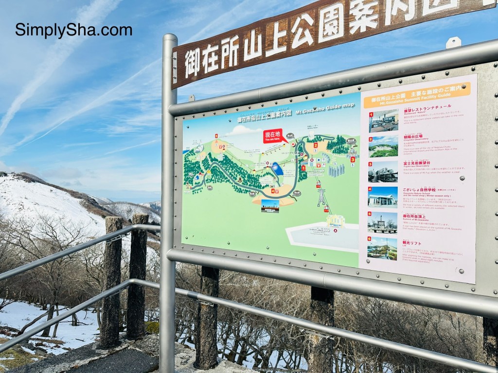 Mt. Gozaisho summit map and information board overlooking the mountains