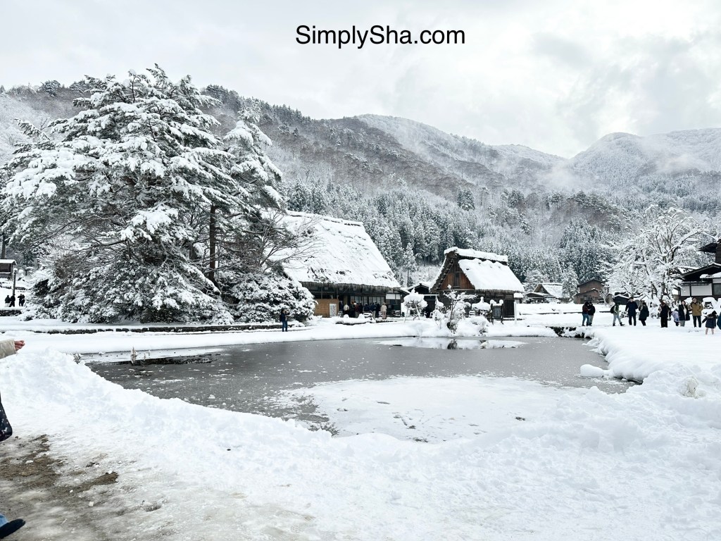 Shirakawa-go village in winter with a frozen pond and snow-covered trees