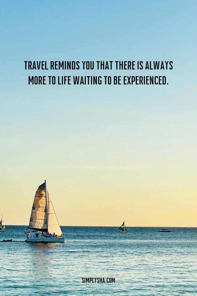 Motivational travel quote about experiencing more in life with a sailboat on calm blue waters at sunset.