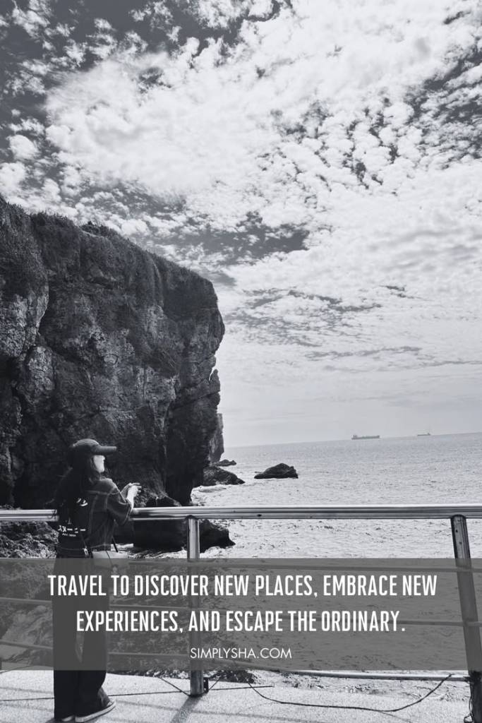 Travel quote about discovering new places and escaping the ordinary with a scenic coastal cliff and ocean view.