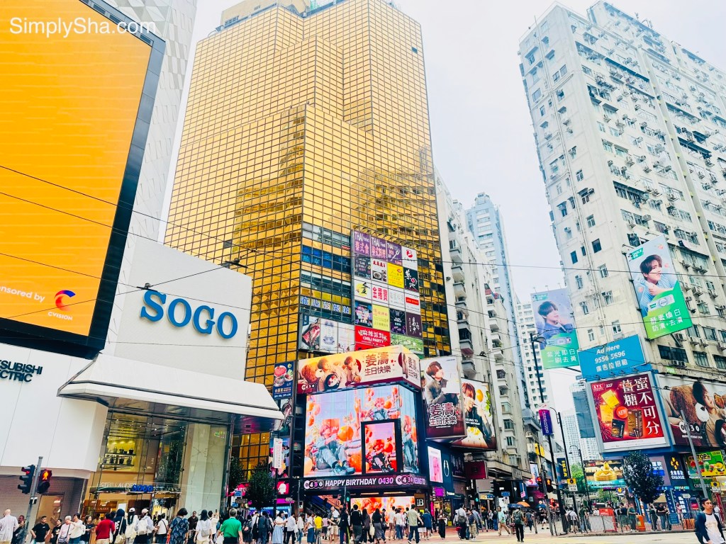 SOGO Department Store surrounded by skyscrapers and busy streets in Causeway Bay, Hong Kong.