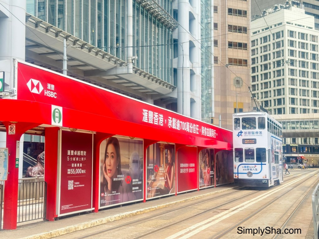 Double-decker Ding Ding Tram traveling along tram tracks in Central, Hong Kong.