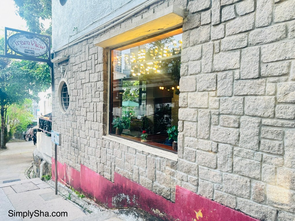 Exterior of Tram View Cafe with its stone walls and large window near Victoria Peak, Hong Kong.